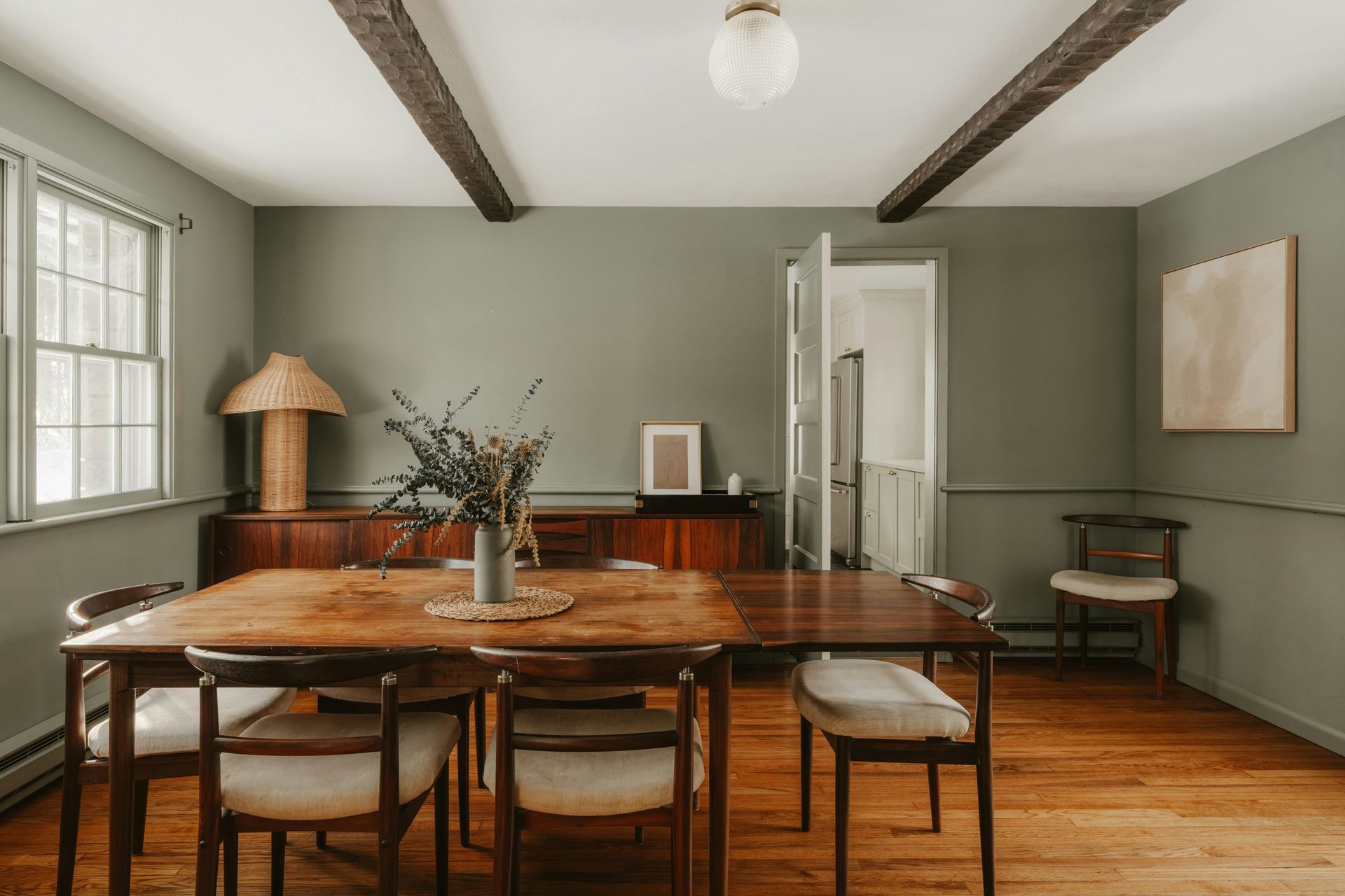 A rustic dining room with wooden table and chairs